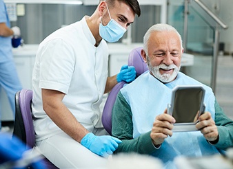Older man learning about oral hygiene