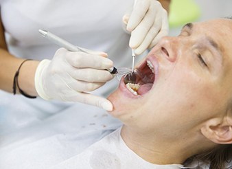 Dentist cleaning a patient’s teeth