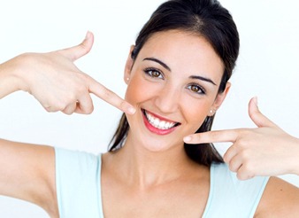 woman pointing to her white smile