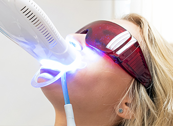 Woman receiving teeth whitening