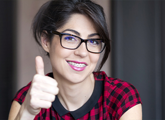 Woman with braces giving thumbs up