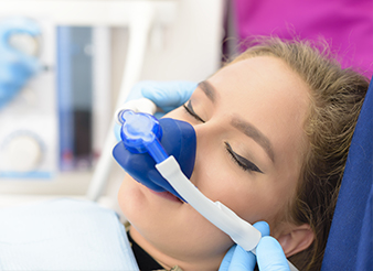 Woman with nitrous oxide nose mask