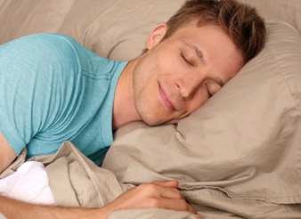 man smiling while sleeping