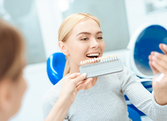 Woman looking at her smile in mirror